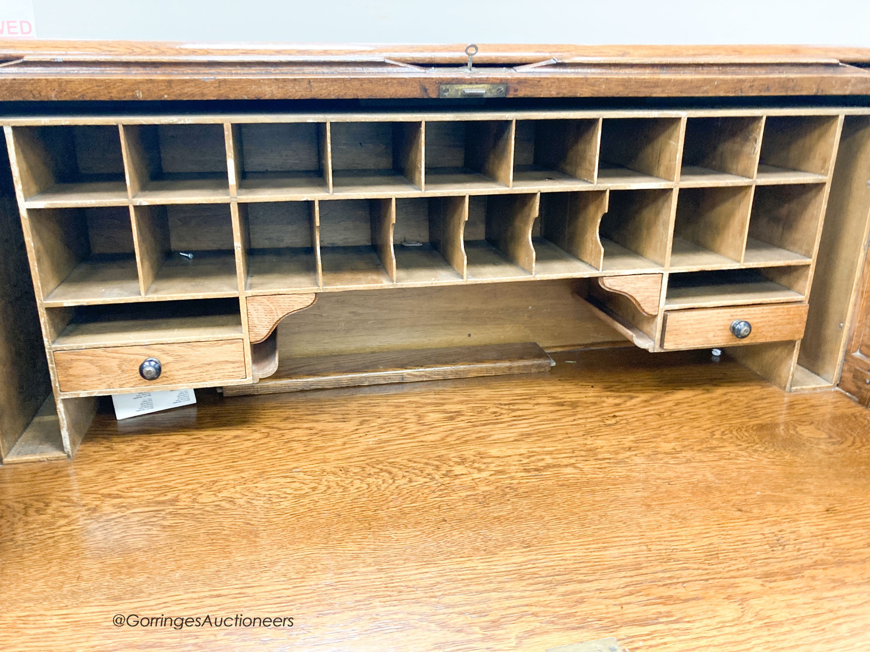 An early 20th century oak roll top desk with 'S' shaped tambour, width 120cm, depth 78cm, height of 124cm